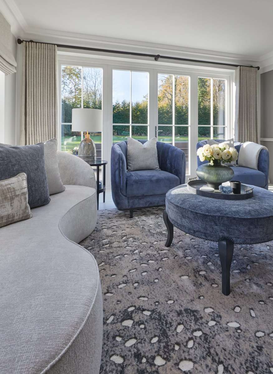 Blue armchairs in a light-filled sitting room