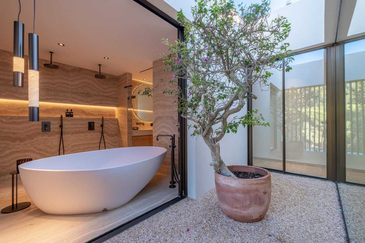 Stone bathroom opening to a courtyard
