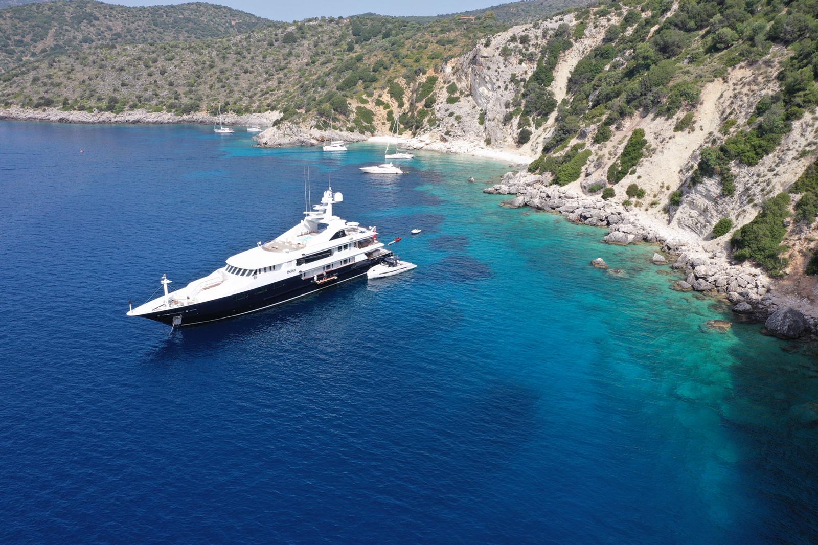 Superyacht cruising in clear blue water
